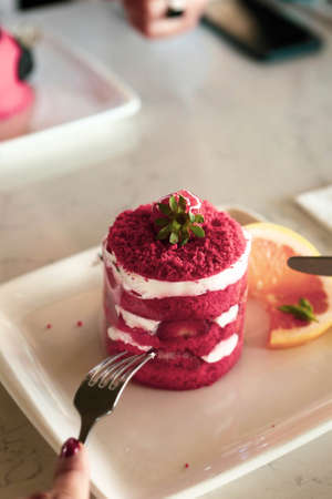 Board with delicious cake on tableの写真素材