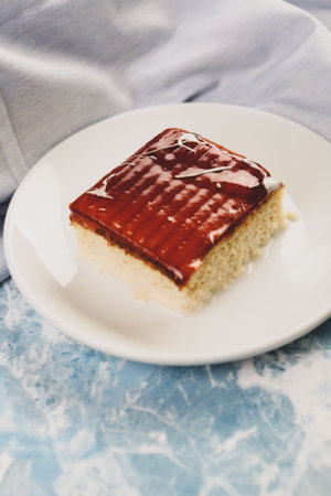 Board with delicious cake on table