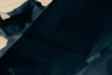 black creased crumpled paper background grunge texture backdropの写真素材