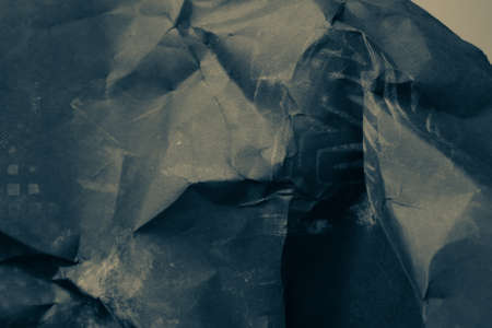black creased crumpled paper background grunge texture backdropの写真素材