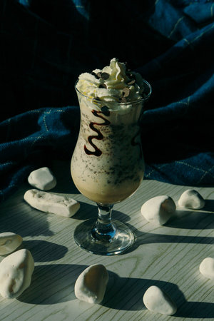 Iced coffee with milk. Iced coffee latte. Woman holding glass cup of iced coffee.