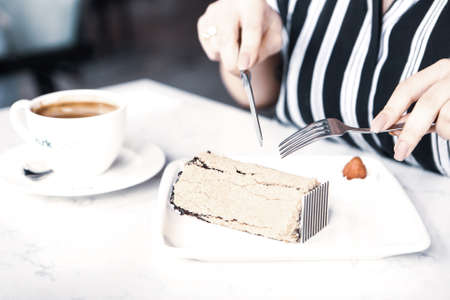 Board with delicious cake on tableの写真素材