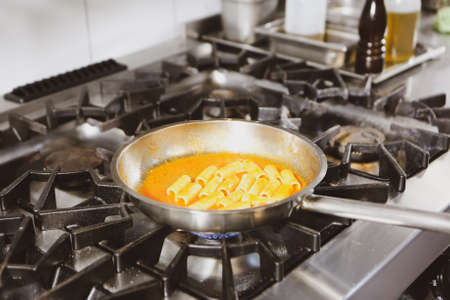 pot with cake on the fire stove cookingの写真素材