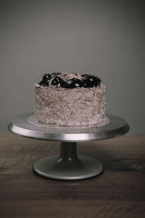 Board with delicious cake on tableの写真素材