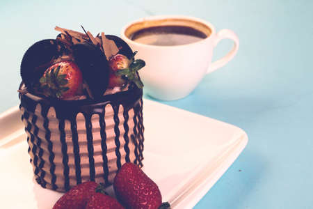 Board with delicious cake on tableの写真素材