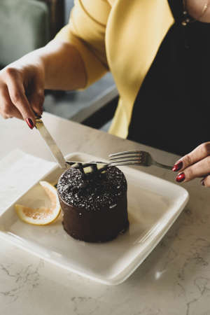 Board with delicious cake on tableの写真素材