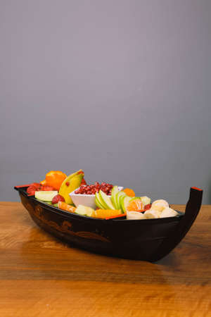 Plate with delicious mixed fruits and sliced fruitsの写真素材
