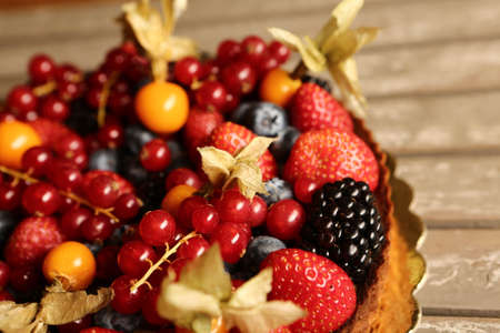 Board with delicious cake on tableの写真素材