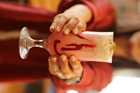 Glass of raspberry milkshake with whipped cream and fresh raspberriesの写真素材