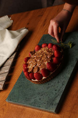 Board with delicious cake on tableの写真素材