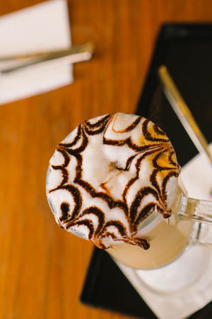 Iced coffee with milk. Iced coffee latte. Woman holding glass cup of iced coffee.の写真素材