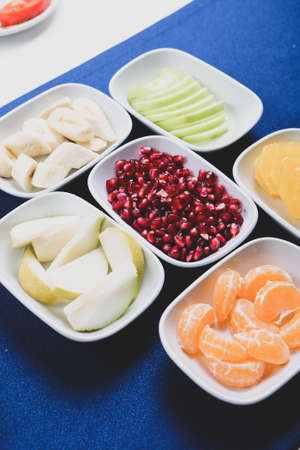 Plate with delicious mixed fruits and sliced fruitsの写真素材