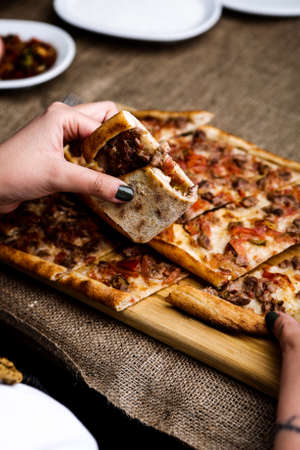 Traditional turkish baked dish pide. Turkish pizza pide, Middle eastern appetizers. Turkish cuisine. Pita with meat fillingの写真素材