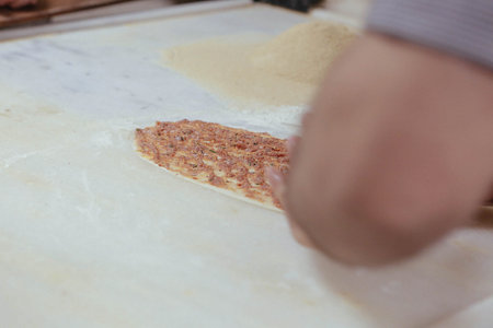 Making a turkish pizza or lahmacun - fast food and popular street food in Mediterranean countries.
