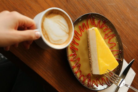 A slice of delicious cake and a cup of coffeeの写真素材