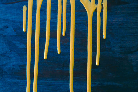 Dripping on a blue wooden background. Selective focus.の写真素材