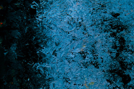 abstract background of blue oil paint on a rusty metal surface close-upの写真素材