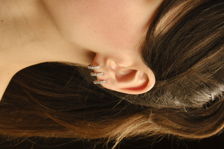 Beautiful girl with long hair on black background, close-upの写真素材