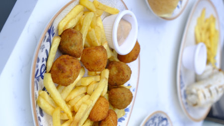 French fries and croquettes on a plate. close upの写真素材