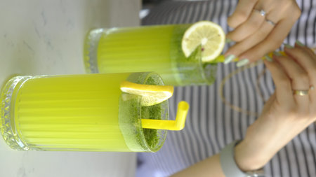 Close-up of glass of fresh lemonade with lime and mint