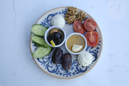 Traditional Turkish breakfast with rice, cheese, cucumber, olives and nutsの写真素材