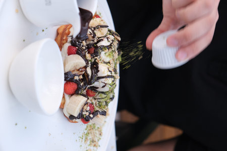 Chocolate waffle with strawberry, banana, peanut butter and chocolate sauceの写真素材