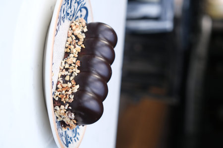 Chocolate macaroon with nuts on the counter of a cafe
