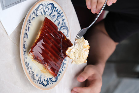 Cheesecake with strawberry sauce in a plate on the table.の写真素材