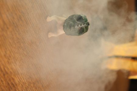Smoke coming out of a bag on a wooden surface with a blurred backgroundの写真素材