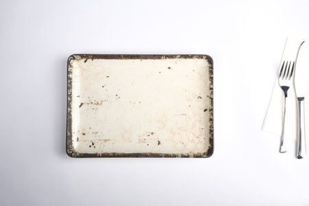 Empty ceramic plate with cutlery on white background, top viewの写真素材