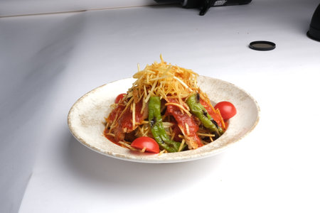 Spicy salad on a white plate on a white backgroundの写真素材