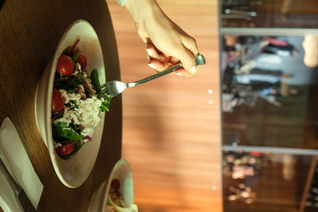 Woman eating salad in restaurant, closeup. Healthy dieting conceptの写真素材