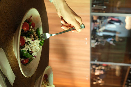 Woman eating fresh salad in cafe, closeup. Dieting conceptの写真素材