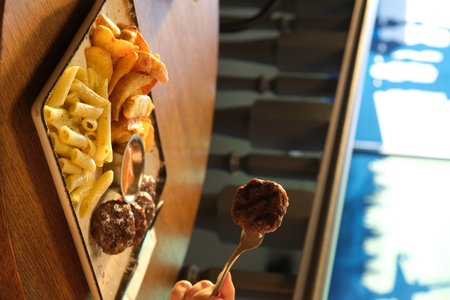 Closeup of french fries and hamburger on the wooden table.の写真素材