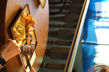 Woman choosing tasty snack in cafe, closeup. Food delivery service