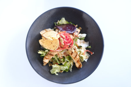 Salad with chicken, vegetables on a white background.の写真素材