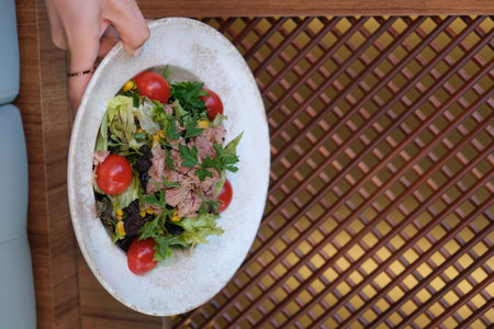 Tuna salad with cherry tomatoes on the tableの写真素材