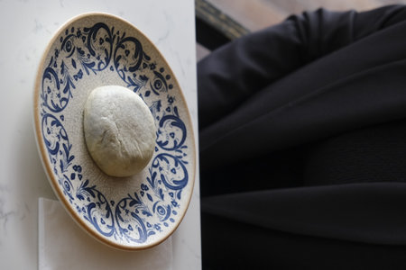 A white stone on a porcelain plateの写真素材