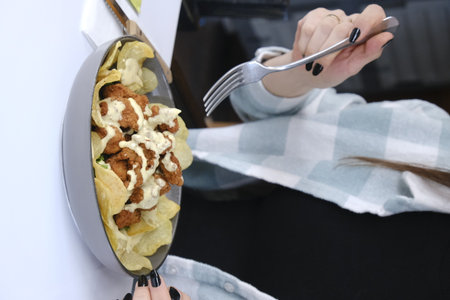 Woman eating in the restaurantの写真素材