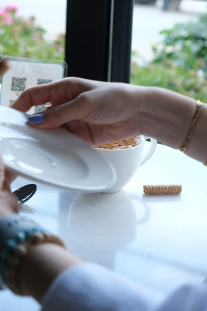 Cup of coffee and cookies on the table in a cafe.の写真素材