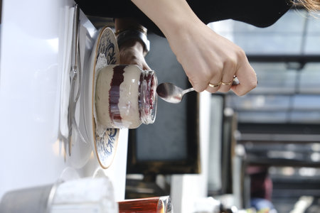 Close-up of a woman's hands making a cup of coffeeの写真素材