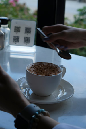 Coffee cup and spoon on table in coffee shop, stock photoの写真素材