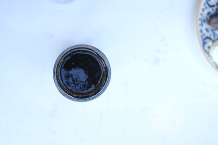 Top view of a glass of black liquid on a white background.の写真素材