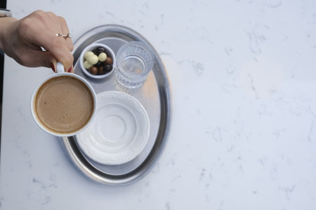 Cup of coffee and chocolate on white marble table, top viewの写真素材