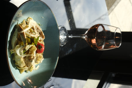 Tasty appetizing classic Italian pasta with meat and vegetables on a restaurant tableの写真素材