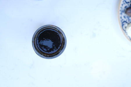 Top view of a glass of black beer on a white table.の写真素材
