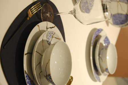 ceramic tableware and cutlery on shelf, closeup of photo