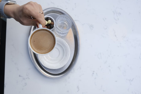 Top view of a cup of coffee on white marble tableの写真素材