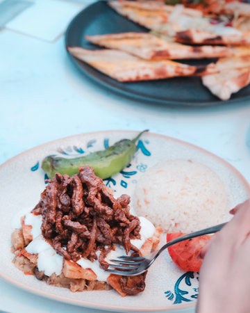 Grilled beef with rice and chilli sauce on white plate.の写真素材