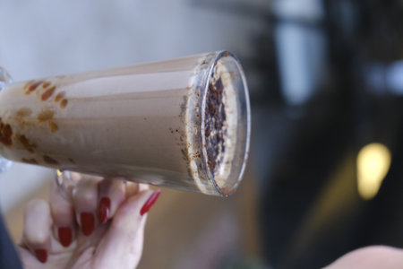 Coffee with milk in a glass on a blurred background.の写真素材